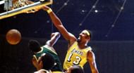 Wilt Chamberlain dunks the ball.